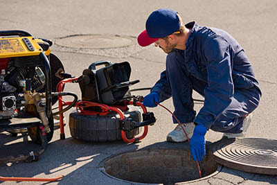 Plumber performing CCTV drain inspection