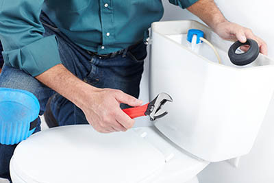 Plumber installing a new toilet